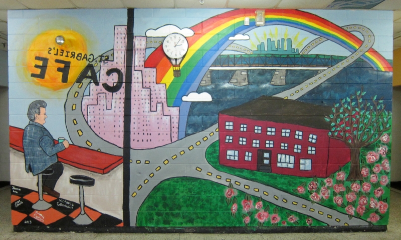 Imagining a future in which the city is their's to claim, the Grade 6 children designing this mural also wanted to include their beloved principal, Jim Daskalaskis, who is recognizably the figure sitting at the 'café', gazing out on the scene.